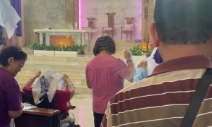 Priest Uses Water Pump to Give Final Blessing