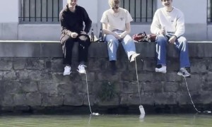 Young Men Chill Beer Cans In River