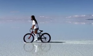 Woman Rides Bike At Bolivia's Salar de Uyuni