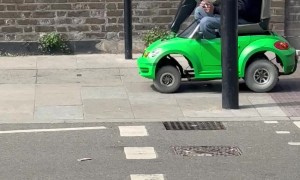 Man Drives Toy Car On London Sidewalk