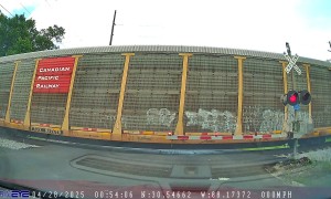 Car Crosses Tracks Before Passing Train