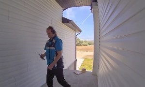 Delivery Man Straightens Up Pile of Packages
