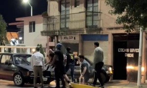 Group of Men Lift a Car Back Over Median