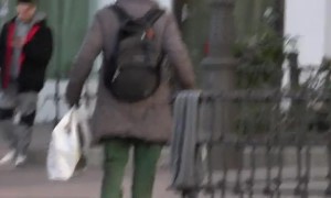 Man Hobbles Along Carrying Groceries