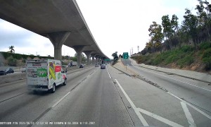 Person Throws a Large Rock on the Freeway
