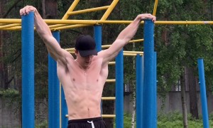 Man Does Pull Up Stunt on Playground Equipment
