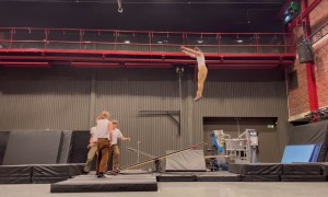 Stomach Stunt On Seesaw By Circus Acrobats