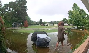 UPS Driver Delivers Heavy Package Through Flooded Yard