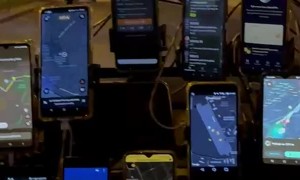 Taxi Driver With Eleven Phones On Windshield