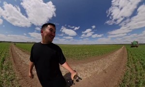 Man Nearly Hit by Giant Spraying Tractor Arm While Walking Through Field