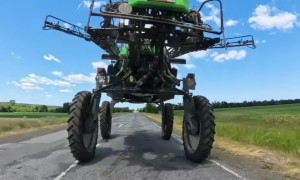 Driving a Motorcycle Under a Field Sprayer