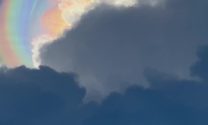Sun Halo Peaks Through Storm Clouds