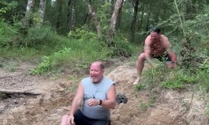 Dad and Stepson Laughing and Slipping on a Sandy Hill
