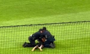 Football Fan Runs on Field at a Baseball Game