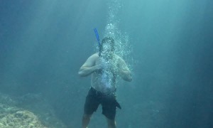 Freediver Blows Bubble Ring From Sea Bottom