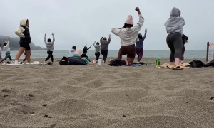 Man Takes a Nap During Sunday Morning Beach Yoga