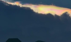 Iridescent Rainbow Peaks Over Clouds