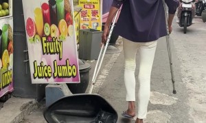 Walking Man Casually Holds Crutches Out