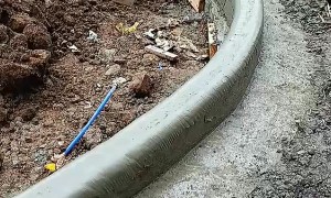 Workers Smooth Concrete With Wet Plastic