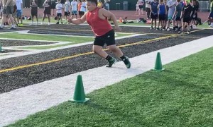 Young Athlete Goes 110% in Football Drill
