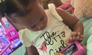 Toddler Uses Tablet as a Waffle Holder