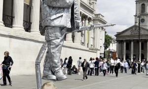 Child Offers Juice to Silverman Statue