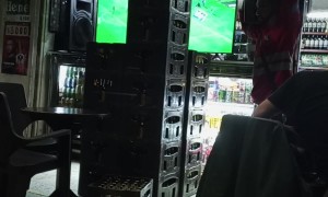 Man Carries Five Full Cases on His Shoulder