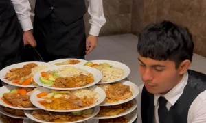 Server Carries Several Piles Of Plates