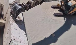 Excavator Knocks Down Travertine Wall