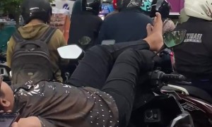 Biker Takes a Nap While Stuck in Gridlock Traffic