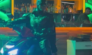 Transformer Dances While Batman Drives a Moped Inside a Bar