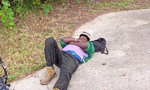 Passerby Checks On Friend Laying By Roadside