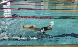 Woman Gives Backstroke Her All