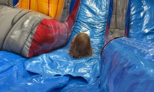 Little Girl Tumbles Down Inflatable Slide
