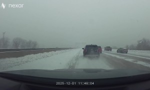 SUV Slides Across Several Lanes During Snowstorm