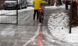 Motorcycle Slides Up Slippery Road