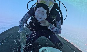 Masked Diver Cleaning Ship Bottom