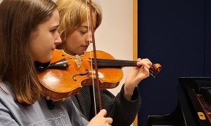 Two Girls Playing Each Others Instruments