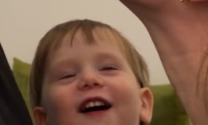 Mom and Dad Kissing in Front of Their Child