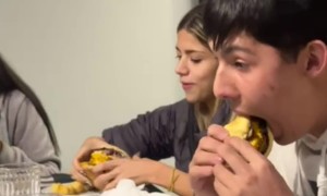 Small Girl Takes Bite of a Triple Burger