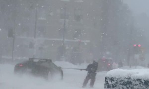Lamborghini Huracan Pulling a Skier Down Snow-Covered Street