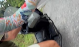 Downhill Traveler Tips Over Around Curve