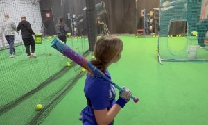 Softball Hits Netting and Comes Down on Coaches Head
