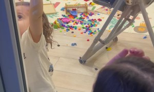 Child Helps His Mother Open the Door