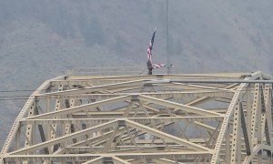 Man Climbs Bridge Illegally and Ties Bicycle to Flag