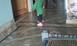 Dad Kicks Soccer Ball at Son