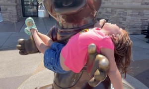 Beaver Mascot Statue Cradles Young Fan