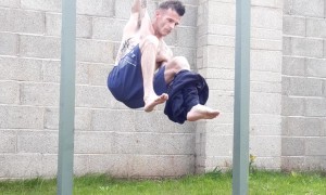 Man Takes Off Clothes While Hanging From Bar