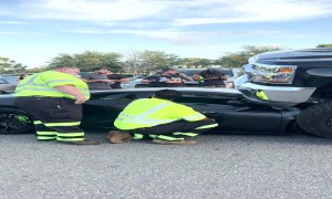 Aftermath of Lifted Truck Driving Over Luxury Sportscar