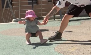 Dad Keeping His Little Girl Steady After a Dizzying Spin at the Park